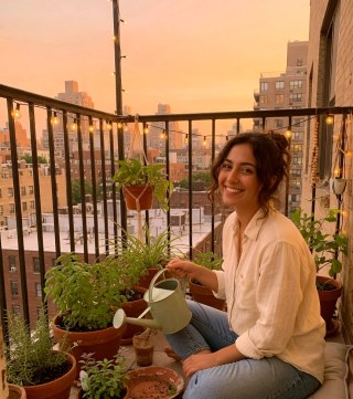 Close portrait — Plant-parent portrait on a golden-hour balcony garden.